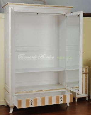 Classic wooden cabinet with white lacquered finish and hand-applied gold leaf